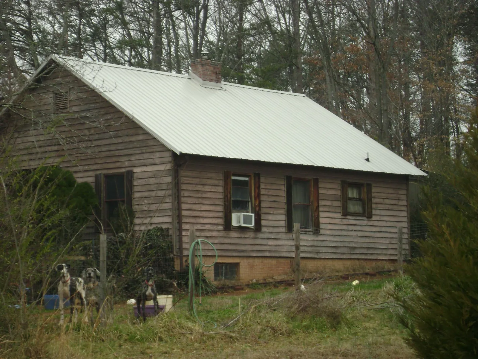 White metal roof on an old wood sided farmhouse, from a Metal Roof Installation job in Adairville